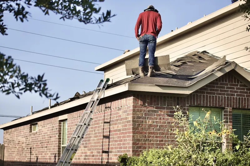 Professional roofer working on a residential roof in Dickinson